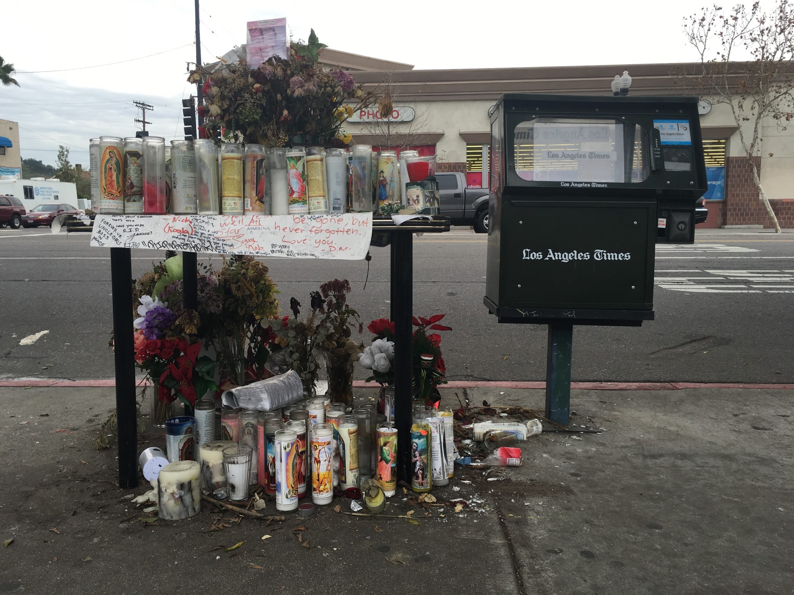 Roadside memorial with vigil candles and framed poem on North Figueroa Street, Los Angeles, 2016